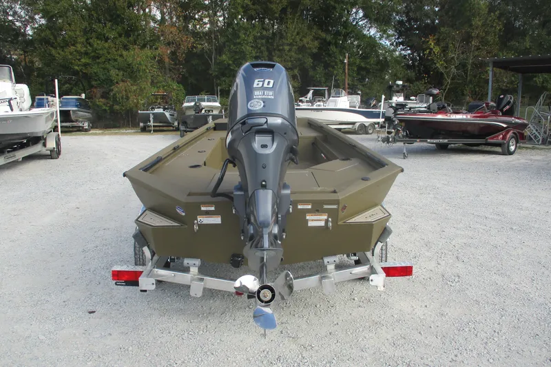 Slide: The Image of Avid 16 Commander 2026 boat with outboard motor in a parking lot. - 4