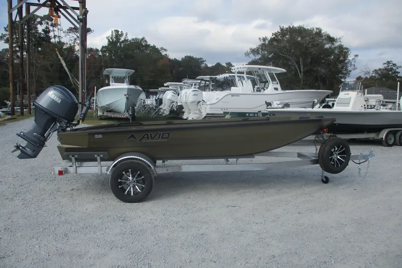 Slide: The Image of 2026 Avid 16 Commander boat on trailer with Yamaha outboard motor in a marina. - 5