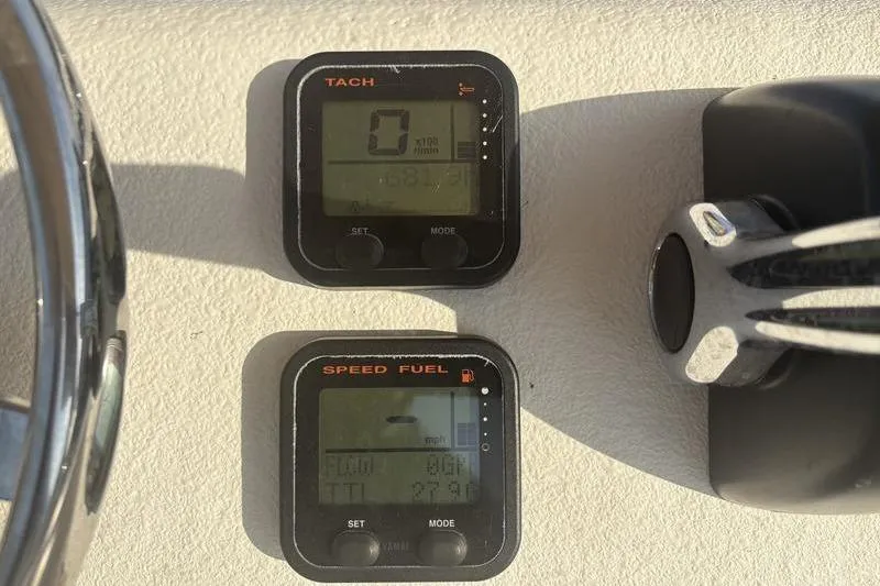 Slide: The Image of Tachometer and speed fuel gauges on a 2014 Reno 23 dashboard. - 12