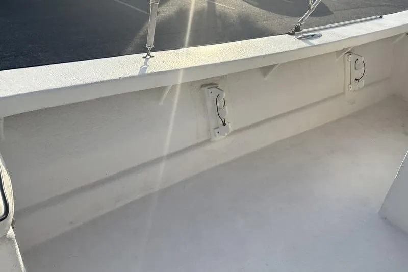Slide: The Image of White interior of a 2014 Reno 23 boat with sunlight streaming in. - 16