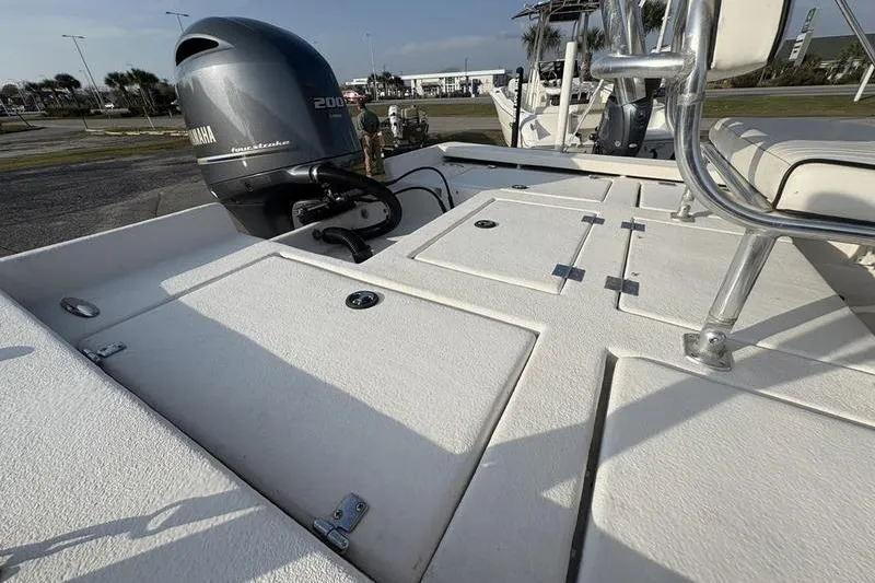 Slide: The Image of Boat deck with Yamaha 200 engine, Reno 23 model, 2014, in a marina setting. - 7