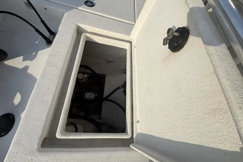 Slide: The Image of Open storage compartment on a 2014 Reno 23 boat, showing internal wiring. - 9