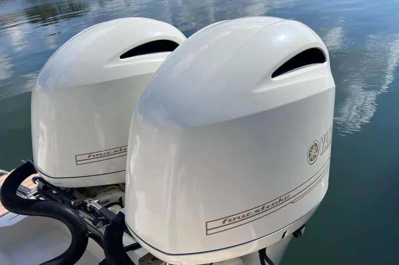 Slide: The Image of Twin Yamaha outboard engines on a 2019 Scout 275 LXF boat, reflecting on water. - 21
