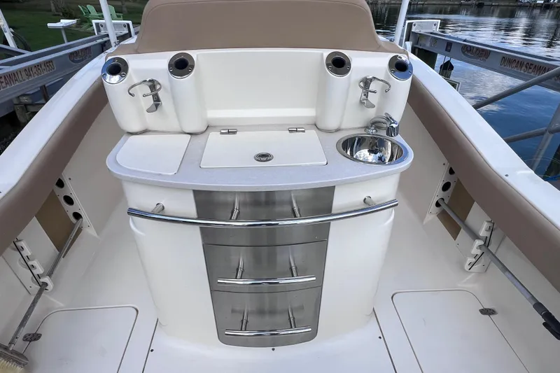 Slide: The Image of 2019 Scout 275 LXF boat interior with sink and storage drawers. - 26