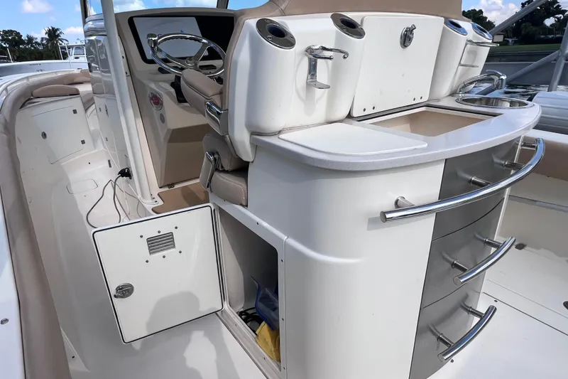 Slide: The Image of 2019 Scout 275 LXF boat interior with helm, storage, and seating. - 29