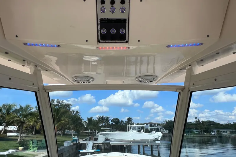 Slide: The Image of 2019 Scout 275 LXF boat interior with LED lights and waterfront view. - 32