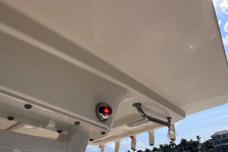 Slide: The Image of 2019 Scout 275 LXF boat roof with mounted light and rod holders. - 33