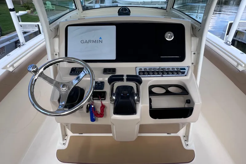 Slide: The Image of 2019 Scout 275 LXF boat dashboard with Garmin display and steering wheel. - 38