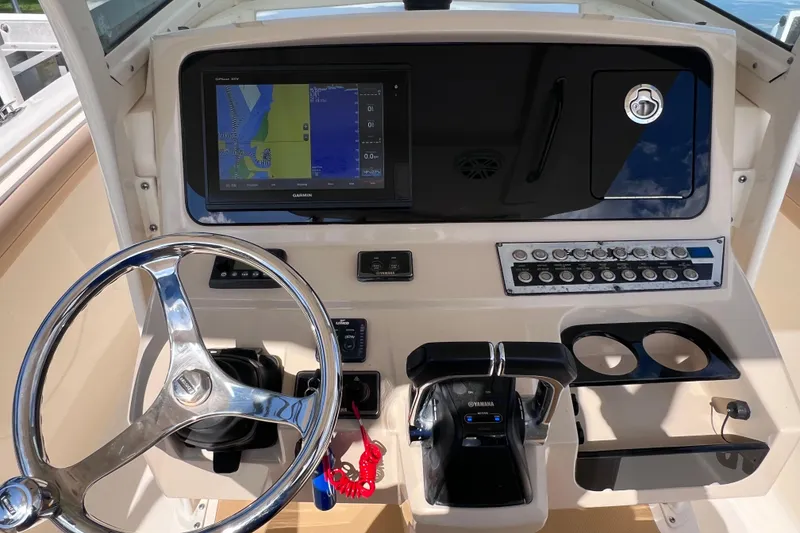Slide: The Image of 2019 Scout 275 LXF boat dashboard with Garmin display and Yamaha controls. - 39