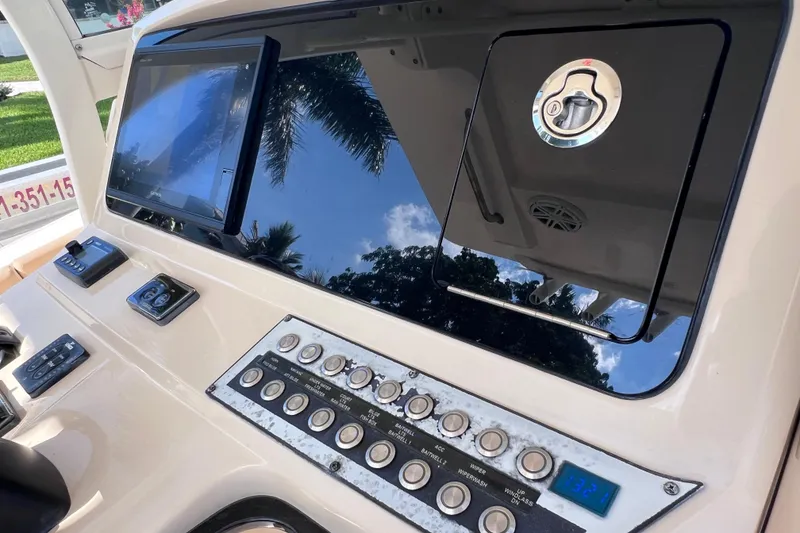 Slide: The Image of 2019 Scout 275 LXF boat dashboard with control panel and touchscreen display. - 41