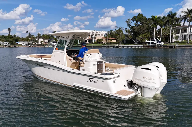 Slide: The Image of 2019 Scout 275 LXF boat on water with Yamaha engines, scenic background. - 5