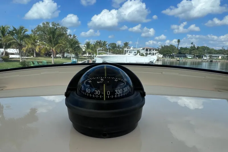 Slide: The Image of Compass on 2019 Scout 275 LXF boat with scenic waterfront view. - 50
