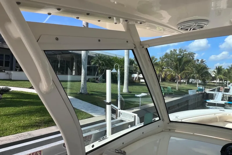 Slide: The Image of 2019 Scout 275 LXF boat interior with waterfront view and palm trees. - 51