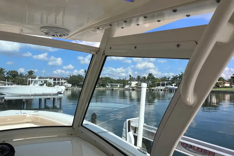 Slide: The Image of 2019 Scout 275 LXF boat interior view at a scenic marina. - 52
