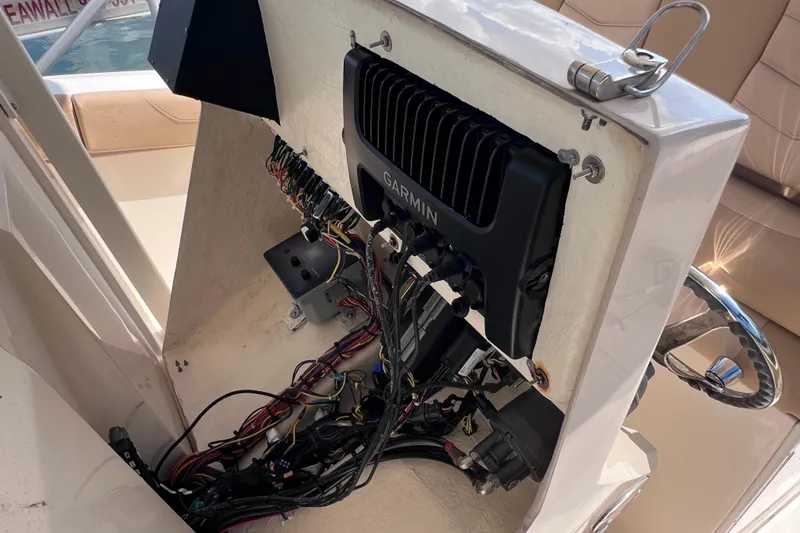 Slide: The Image of 2019 Scout 275 LXF boat console with Garmin electronics and wiring exposed. - 53