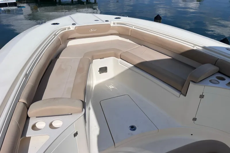 Slide: The Image of 2019 Scout 275 LXF boat interior with beige seating and cup holders. - 54