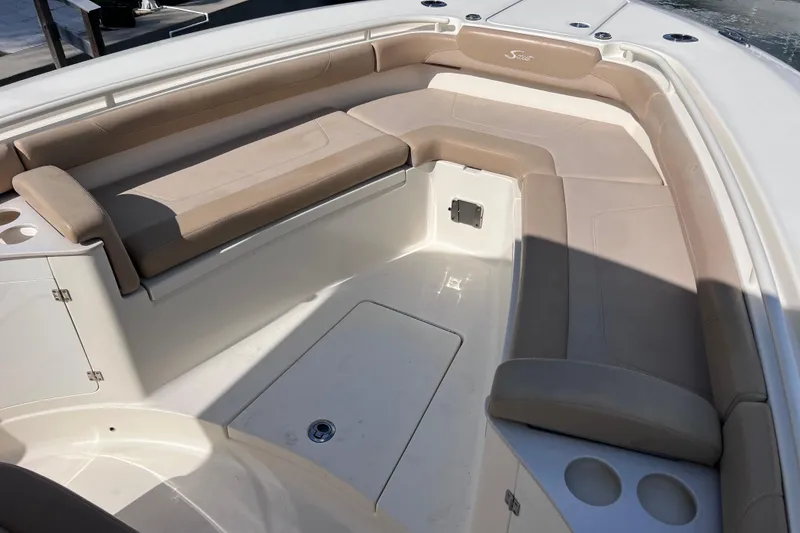 Slide: The Image of 2019 Scout 275 LXF boat interior with beige seating and cup holders. - 55