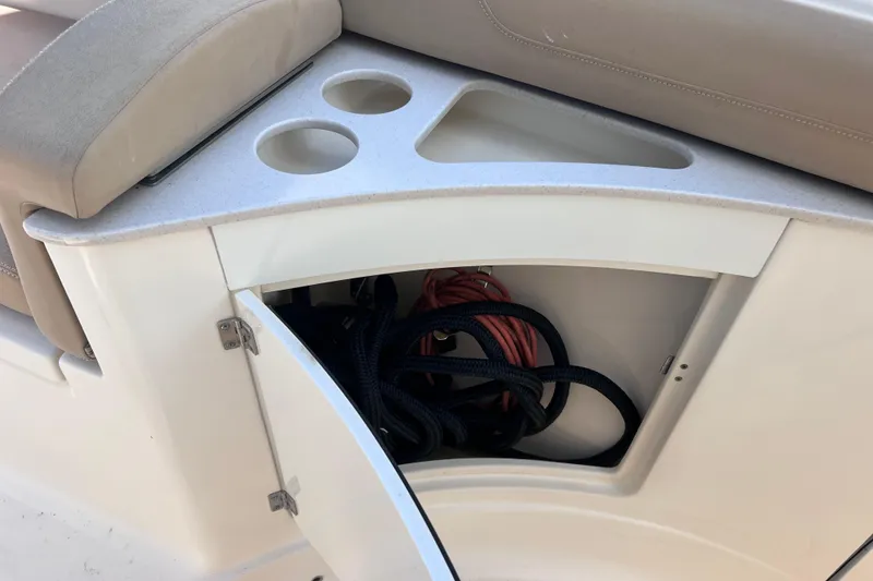 Slide: The Image of 2019 Scout 275 LXF boat storage compartment with cup holders and ropes. - 56