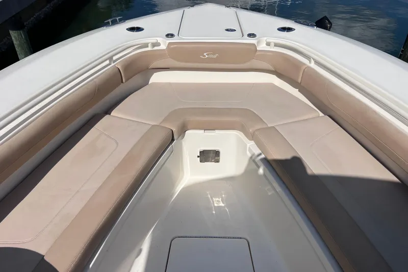 Slide: The Image of 2019 Scout 275 LXF boat interior with beige seating and white deck. - 58