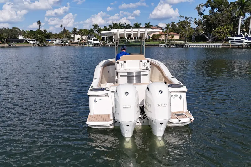 Slide: The Image of 2019 Scout 275 LXF boat with dual engines on calm water. - 6