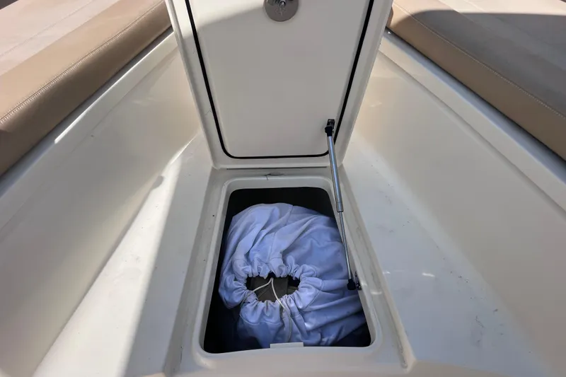 Slide: The Image of Storage compartment on a 2019 Scout 275 LXF boat with cushioned seating. - 60