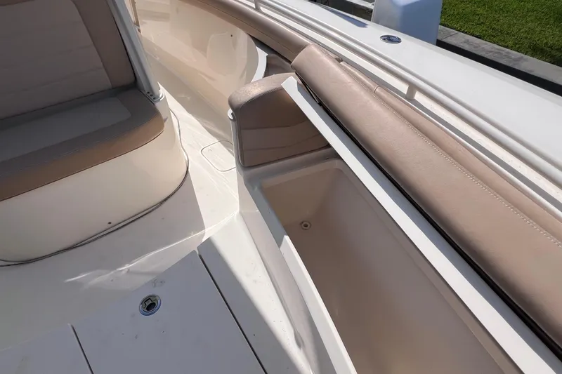 Slide: The Image of 2019 Scout 275 LXF boat interior with seating and storage compartment. - 63
