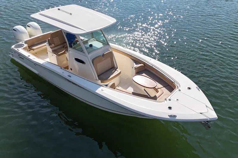 Slide: The Image of 2019 Scout 275 LXF boat on water, featuring sleek design and spacious seating. - 7