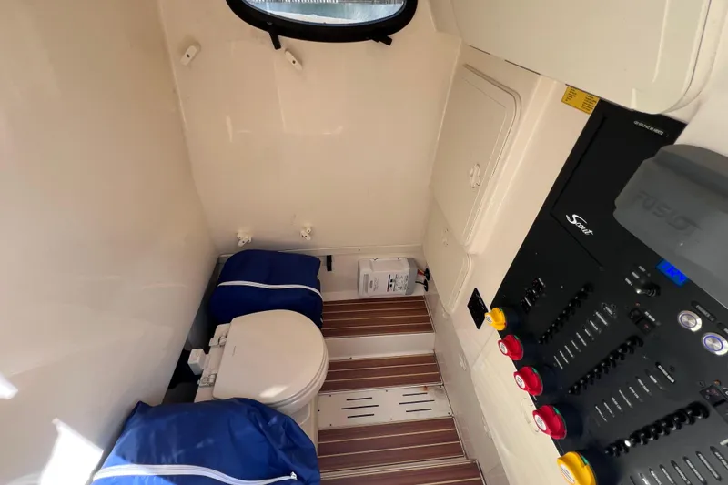 Slide: The Image of Interior of 2019 Scout 275 LXF boat featuring a compact bathroom and control panel. - 73