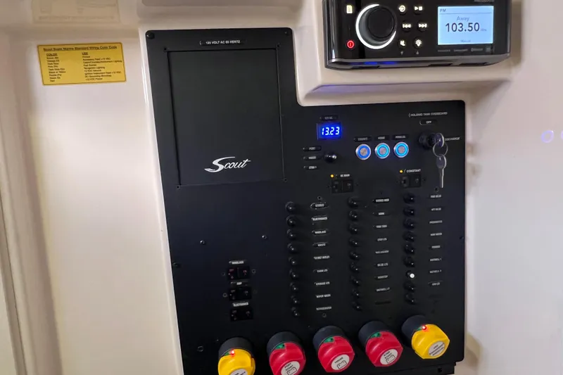 Slide: The Image of Control panel of a 2019 Scout 275 LXF boat with various switches and displays. - 76