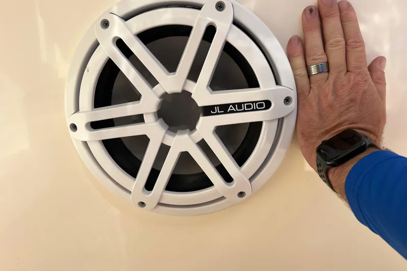 Slide: The Image of Hand next to JL Audio speaker on 2019 Scout 275 LXF boat. - 79
