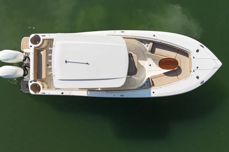 Slide: The Image of Top view of a 2019 Scout 275 LXF boat on green water. - 8