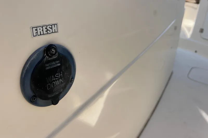 Slide: The Image of 2019 Scout 275 LXF boat washdown outlet labeled "Fresh." - 80