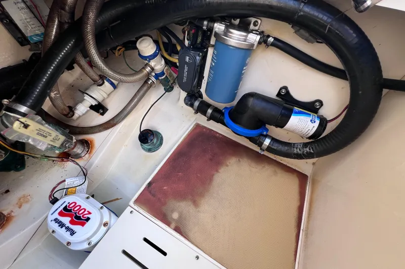 Slide: The Image of Engine compartment of a 2019 Scout 275 LXF boat, showcasing hoses and filters. - 83