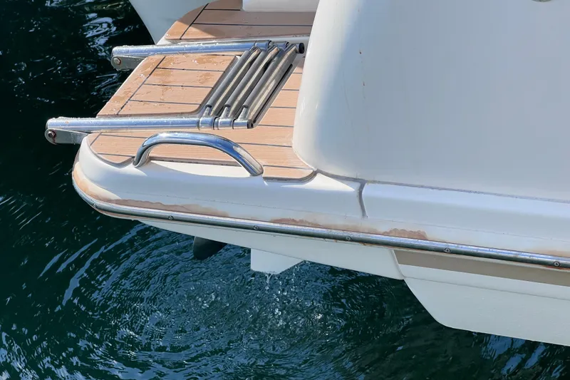 Slide: The Image of 2019 Scout 275 LXF boat swim platform with ladder over water. - 84