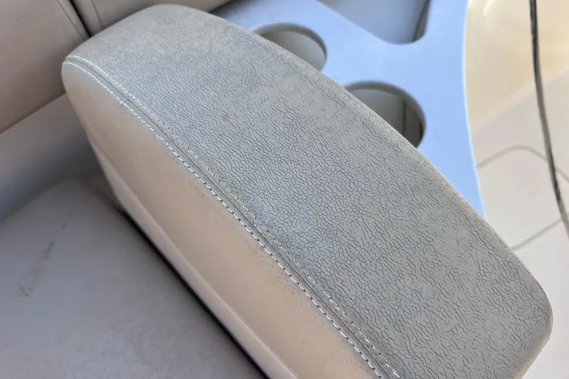 Slide: The Image of Close-up of 2019 Scout 275 LXF boat seat with textured upholstery and cup holders. - 88