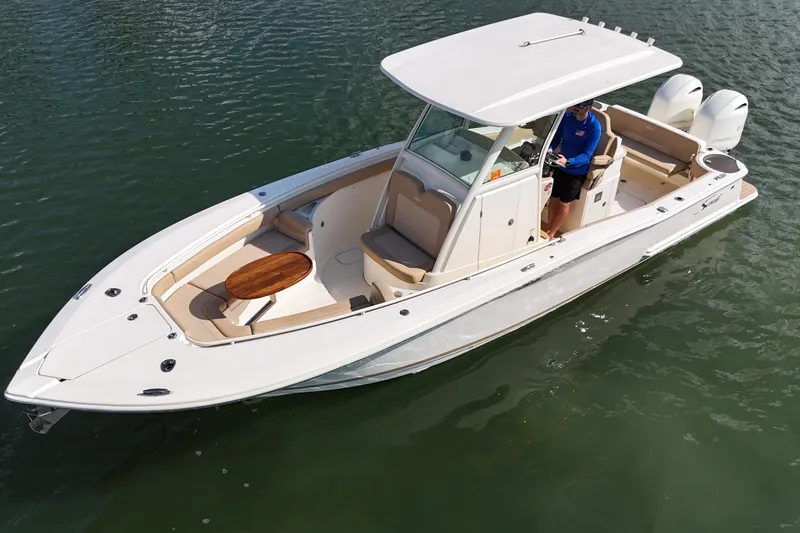 Slide: The Image of 2019 Scout 275 LXF boat on water, featuring sleek design and dual engines. - 9