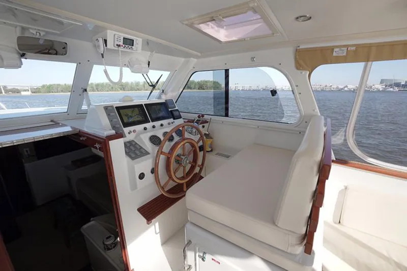 Slide: The Image of Interior of 2003 Huckins 44 Atlantic yacht with steering wheel and navigation equipment. - 18