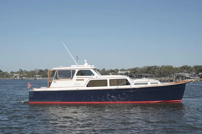Slide: The Image of 2003 Huckins 44 Atlantic yacht on calm water, side view. - 2