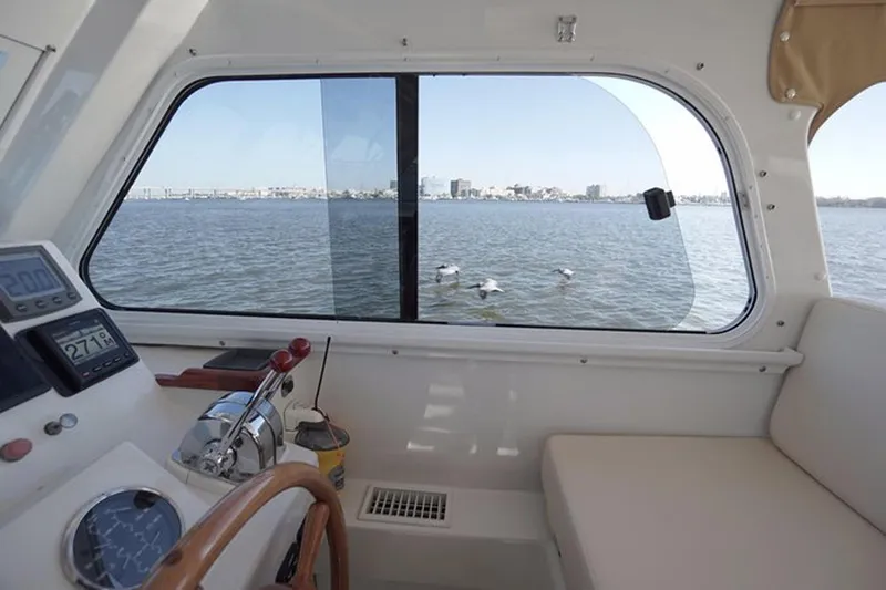 Slide: The Image of Interior view of 2003 Huckins 44 Atlantic yacht with water and cityscape through window. - 22