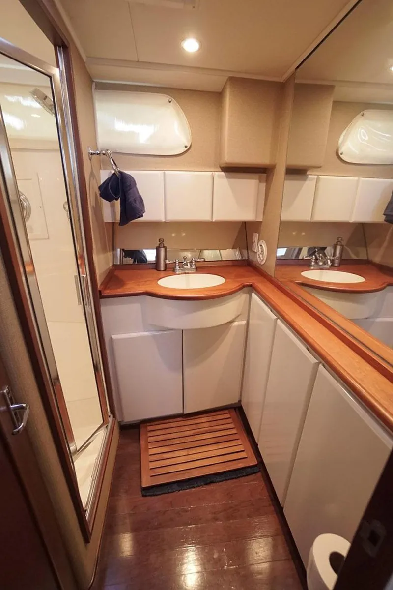 Slide: The Image of Luxurious bathroom in 2003 Huckins 44 Atlantic yacht with wood accents and modern fixtures. - 31
