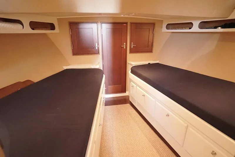 Slide: The Image of Cabin interior of 2003 Huckins 44 Atlantic yacht with twin beds and wooden cabinets. - 32
