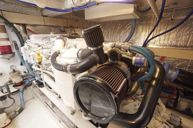 Slide: The Image of Engine room of a 2003 Huckins 44 Atlantic yacht, showcasing complex machinery and components. - 37