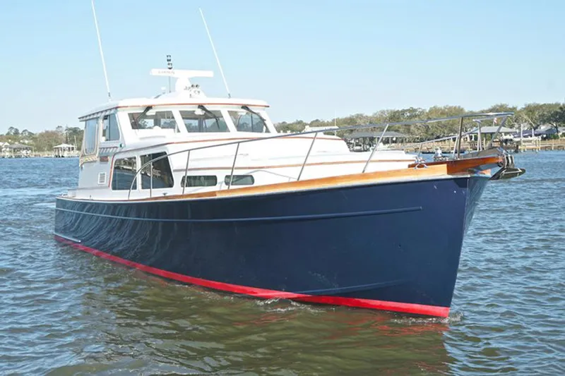 Slide: The Image of 2003 Huckins 44 Atlantic yacht cruising on calm waters. - 4