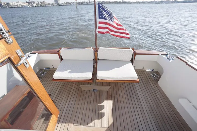 Slide: The Image of 2003 Huckins 44 Atlantic yacht deck with seating and American flag. - 6