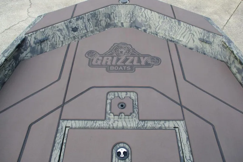 Slide: The Image of 2026 Tracker Grizzly 1860 CC boat deck with camouflage design and logo. - 10