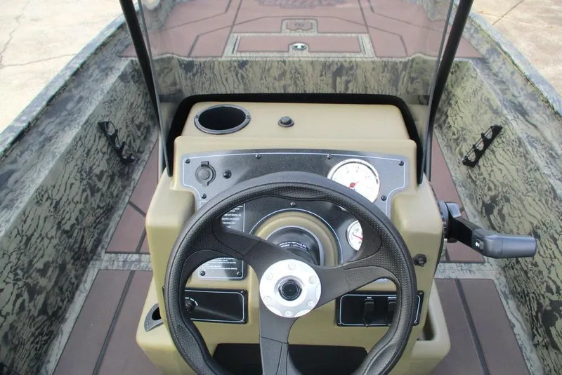 Slide: The Image of 2026 Tracker Grizzly 1860 CC boat console with steering wheel and gauges. - 2