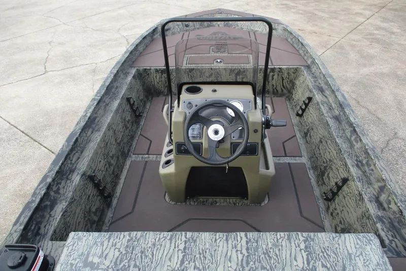 Slide: The Image of 2026 Tracker Grizzly 1860 CC boat interior with steering console and camouflage design. - 5