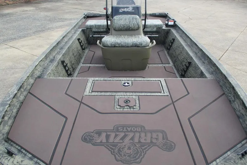 Slide: The Image of 2026 Tracker Grizzly 1860 CC boat interior with camo seating and spacious deck. - 7