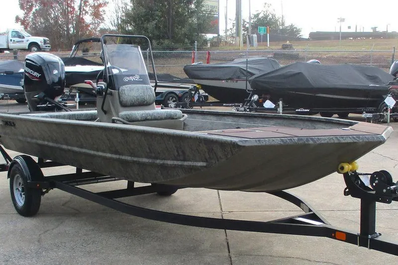 Slide: The Image of 2026 Tracker Grizzly 1860 CC boat on trailer in outdoor showroom. - 8