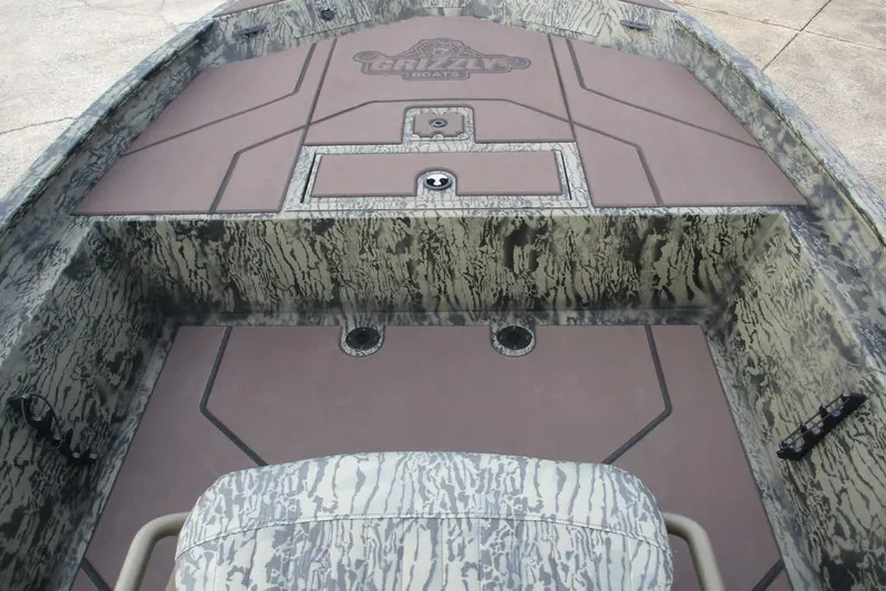 Slide: The Image of 2026 Tracker Grizzly 1860 CC boat interior with camouflage design and spacious deck layout. - 9